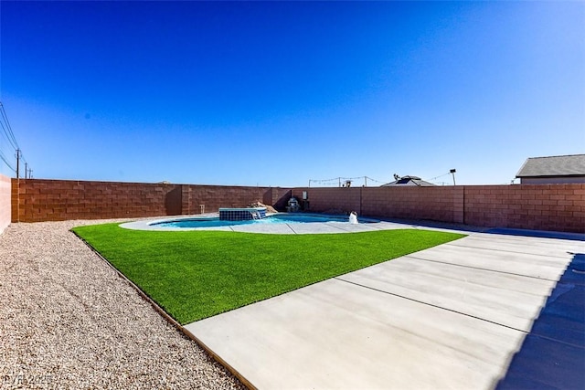 view of yard with a fenced in pool and a patio