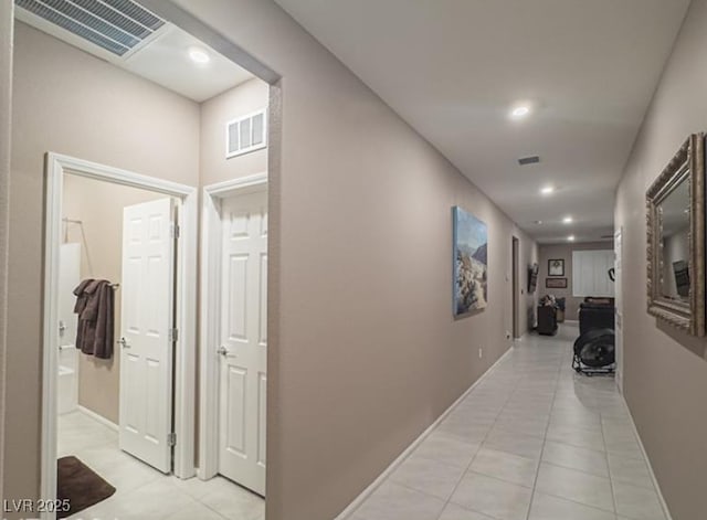 corridor featuring light tile patterned floors