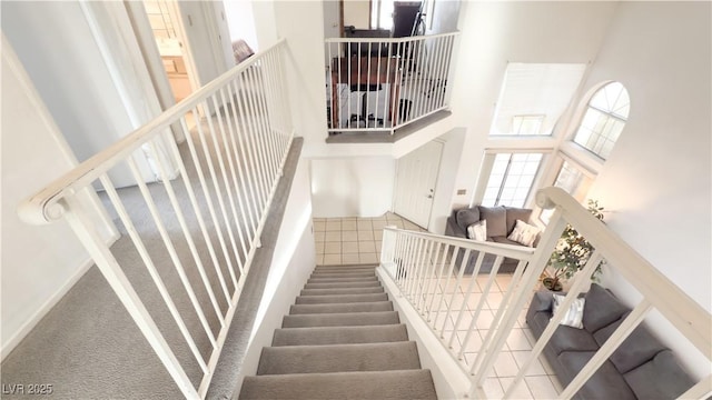 staircase with a high ceiling