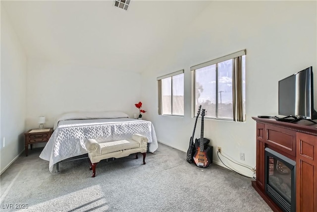 bedroom featuring lofted ceiling and light colored carpet