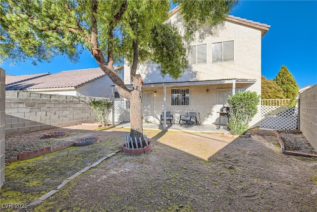 back of property featuring a patio