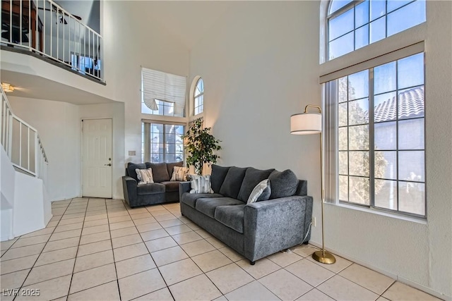 living room with light tile patterned floors and a high ceiling