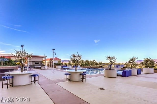 view of patio with exterior bar and area for grilling