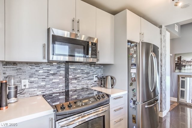 kitchen featuring decorative backsplash, white cabinetry, and stainless steel appliances