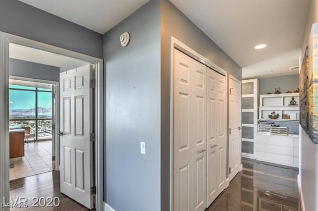 hallway with dark hardwood / wood-style flooring