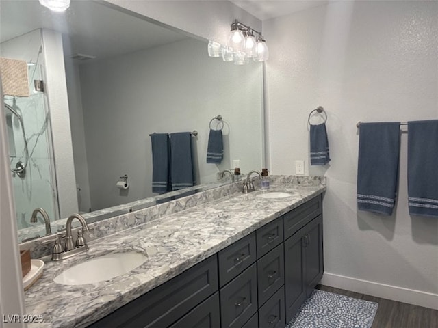 bathroom with wood-type flooring, vanity, and walk in shower