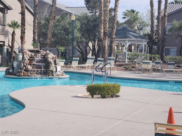 view of pool with a patio area and pool water feature