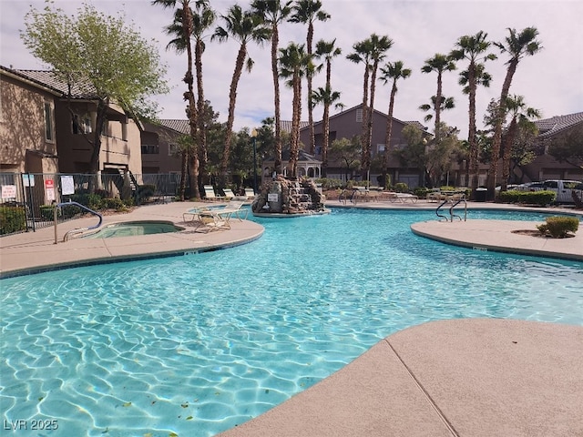 view of pool featuring a patio and a hot tub