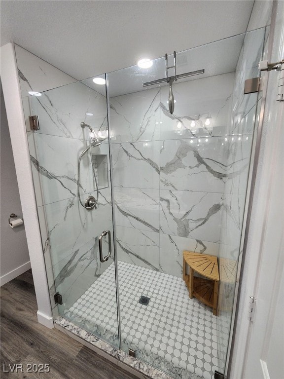 bathroom featuring hardwood / wood-style floors and walk in shower