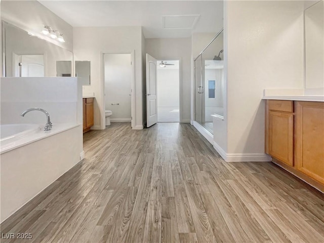 full bathroom featuring separate shower and tub, hardwood / wood-style flooring, vanity, and toilet