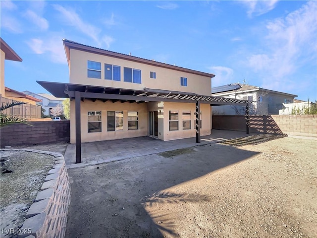 back of property with a patio