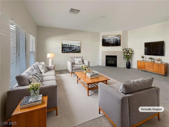 carpeted living room featuring a fireplace