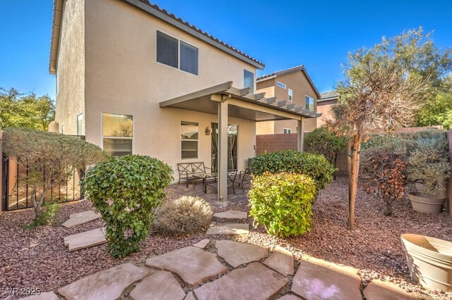 rear view of property featuring a patio area