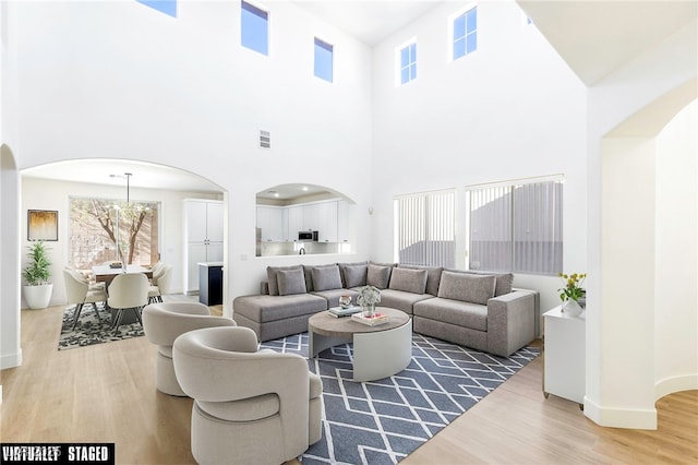 living room featuring a high ceiling and hardwood / wood-style flooring