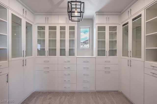 walk in closet featuring light colored carpet