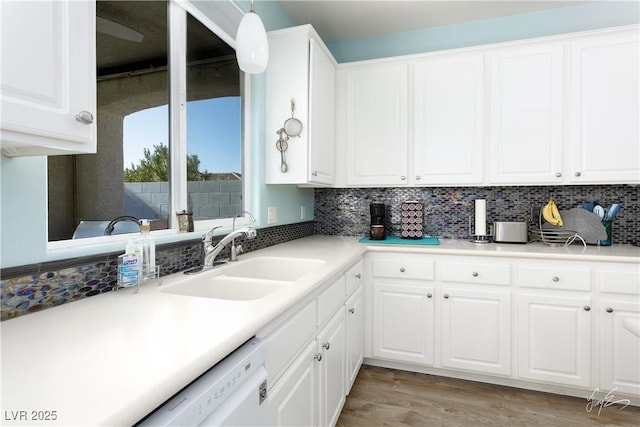 kitchen featuring sink, backsplash, white cabinets, and light hardwood / wood-style floors