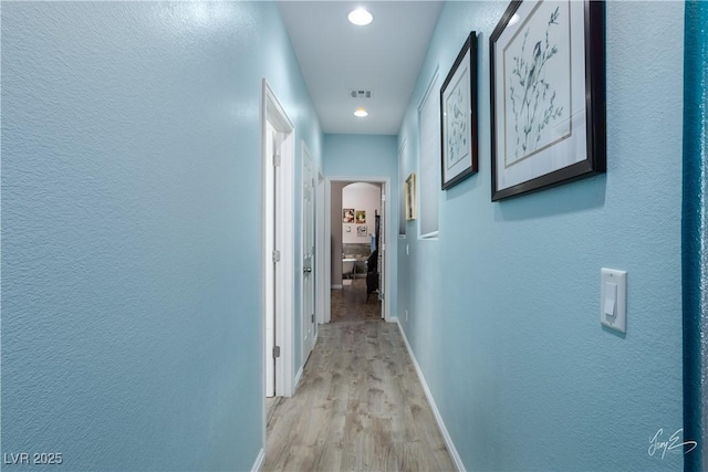 hall with light wood-type flooring