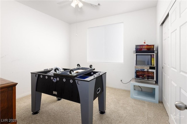 recreation room featuring ceiling fan and carpet