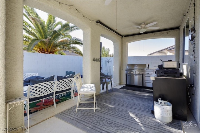 wooden deck with area for grilling, ceiling fan, and a grill