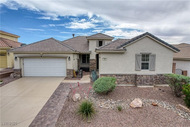 206 Pebble Creek Hts, Mesquite, NV 89027 - view of front of house with stucco siding, stone siding, driveway, and an attached garage