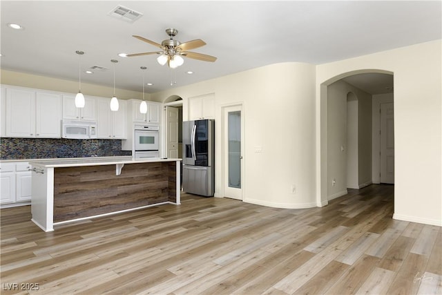 206 Pebble Creek Hts, Mesquite, NV 89027 - kitchen with white appliances, arched walkways, ceiling fan, light wood-type flooring, and recessed lighting