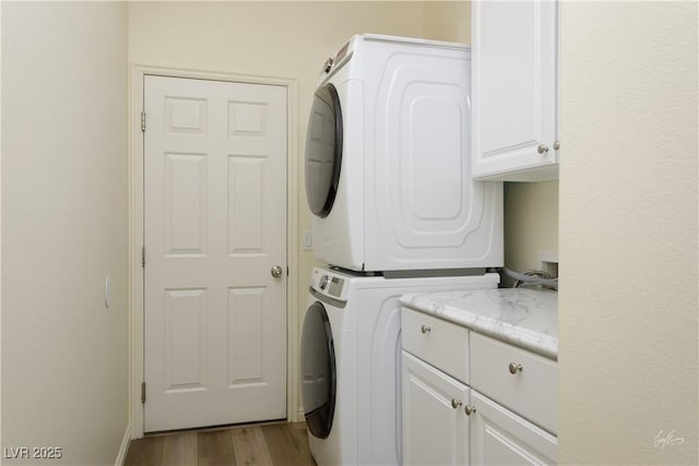 206 Pebble Creek Hts, Mesquite, NV 89027 - clothes washing area featuring cabinet space, estacked washer and dryer, and wood finished floors