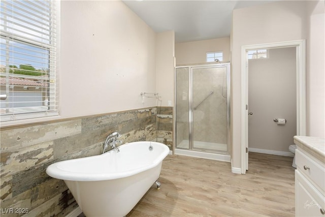 206 Pebble Creek Hts, Mesquite, NV 89027 - full bathroom featuring a shower stall, tile walls, wood finished floors, a freestanding tub, and toilet