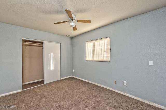 unfurnished bedroom featuring carpet flooring, ceiling fan, a closet, and a textured ceiling