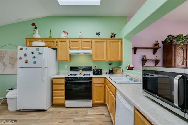 kitchen featuring sink, vaulted ceiling, white appliances, and light hardwood / wood-style floors