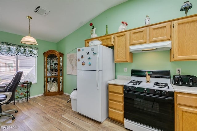 kitchen featuring white fridge, range with gas stovetop, light hardwood / wood-style floors, pendant lighting, and lofted ceiling