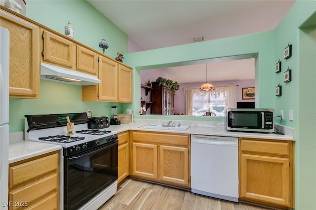 kitchen with sink, decorative light fixtures, dishwasher, gas range oven, and light hardwood / wood-style floors