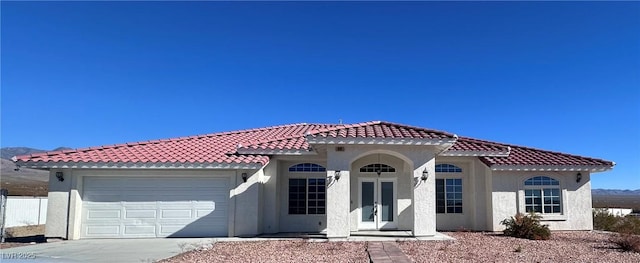 mediterranean / spanish-style house with a garage