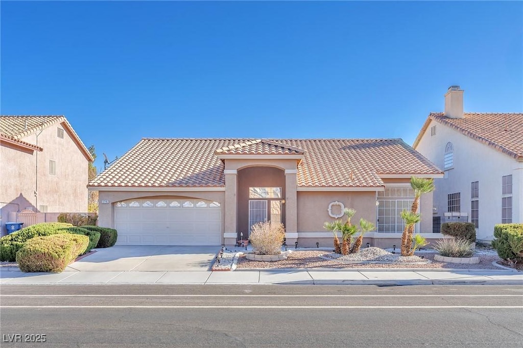 mediterranean / spanish-style house with a garage