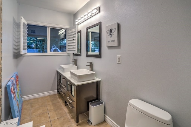 bathroom featuring toilet, tile patterned flooring, and vanity