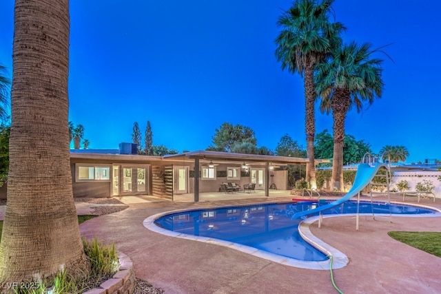 view of pool featuring a water slide and a patio