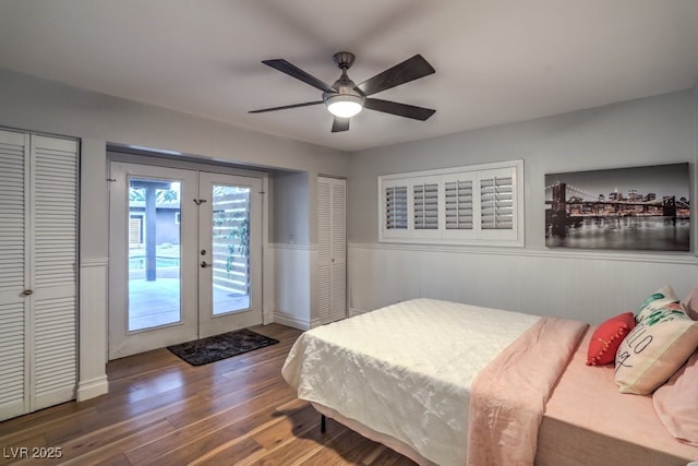 bedroom with ceiling fan, access to exterior, dark hardwood / wood-style floors, two closets, and french doors