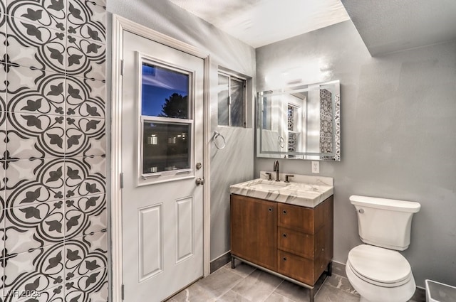 bathroom with toilet and vanity