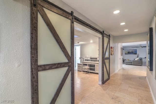 hall featuring a barn door