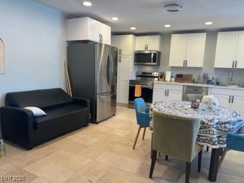 kitchen featuring white cabinets, appliances with stainless steel finishes, and sink