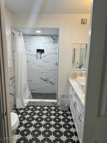 bathroom featuring toilet, vanity, and a shower with shower curtain