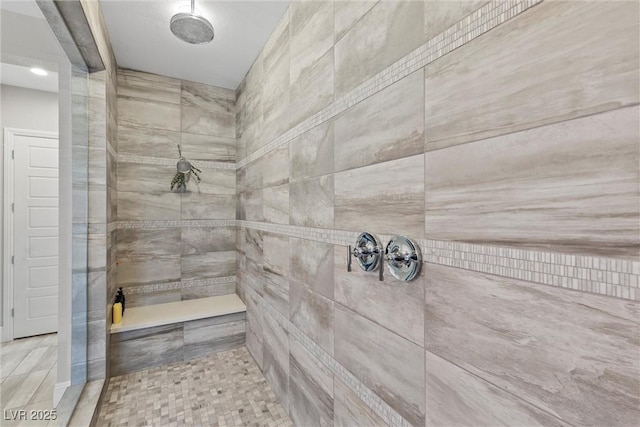 bathroom with tiled shower