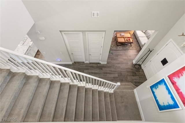 staircase with wood-type flooring