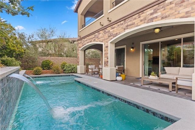 view of pool featuring pool water feature, a patio, and an outdoor hangout area