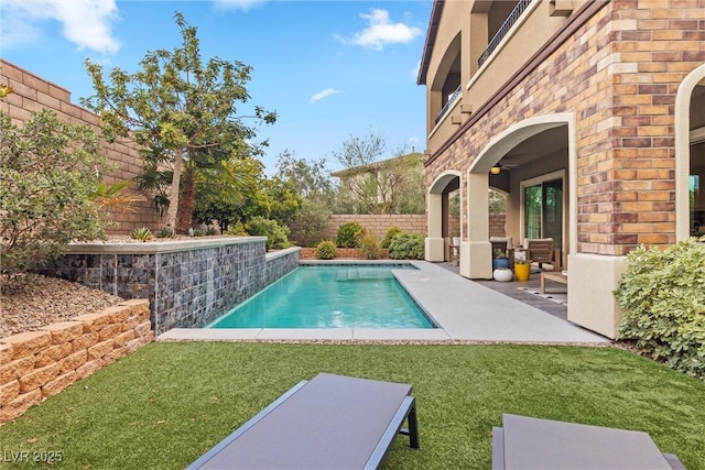 view of swimming pool featuring a patio and a lawn