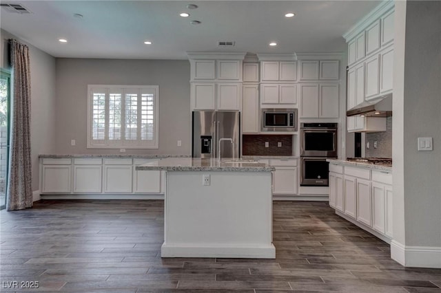 kitchen featuring plenty of natural light, visible vents, appliances with stainless steel finishes, and under cabinet range hood