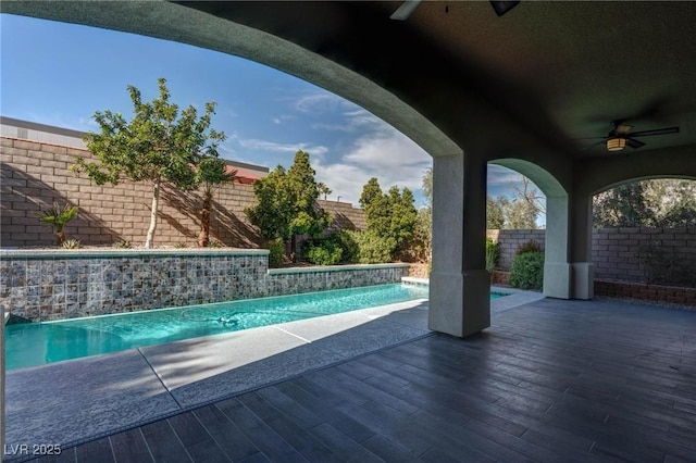 view of pool with a fenced backyard, a ceiling fan, and a fenced in pool