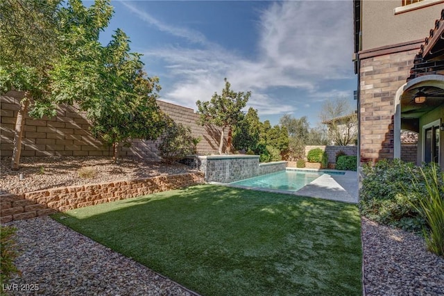 view of yard featuring an outdoor pool and a fenced backyard