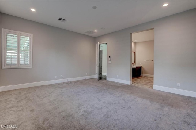 empty room with visible vents, baseboards, and recessed lighting