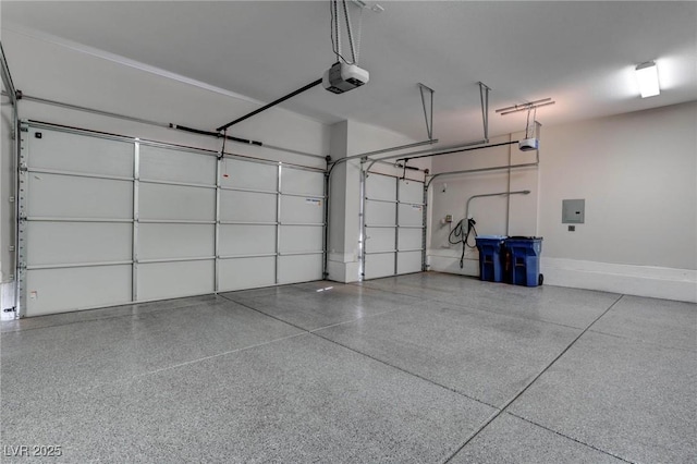 garage with electric panel, baseboards, and a garage door opener