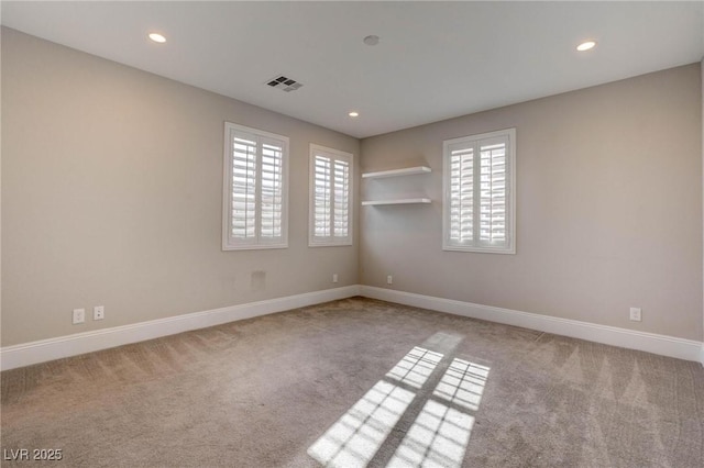 carpeted spare room with recessed lighting, visible vents, and baseboards